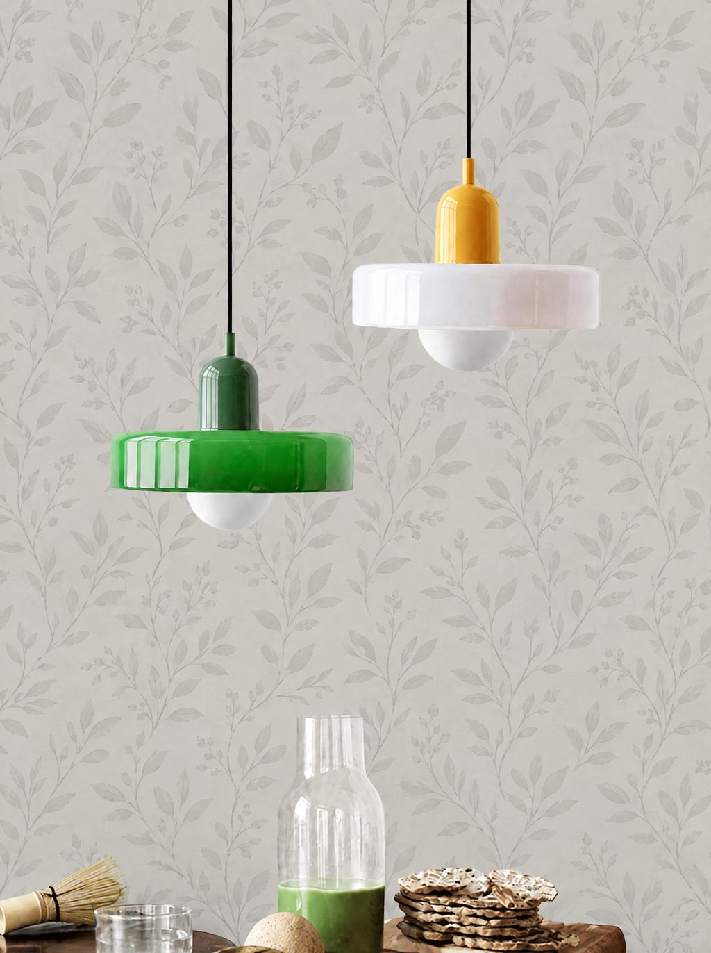 Green and white glass disc pendant lights against light grey botanical wallpaper
