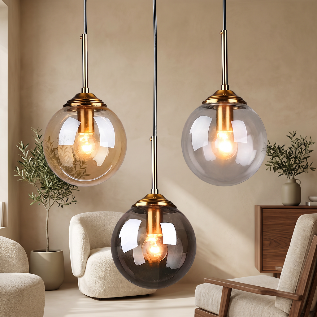 Amber, clear and smoky grey glass globe pendants with brass details in a warm beige living room