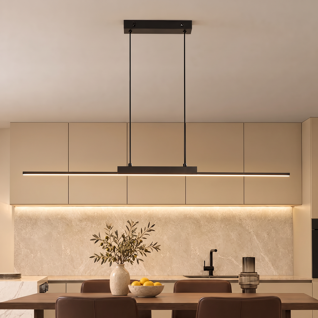 Minimalist black linear LED pendant light glowing warmly in a kitchen with warm beige cabinets, a walnut table and chocolate brown leather chairs