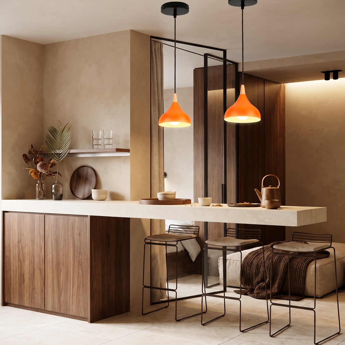Orange teardrop pendant lights over a kitchen island with walnut cabinetry and a warm beige wall