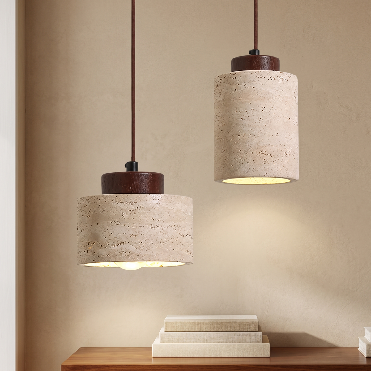 Two travertine pendant lights with dark wood caps against a warm beige limewash wall