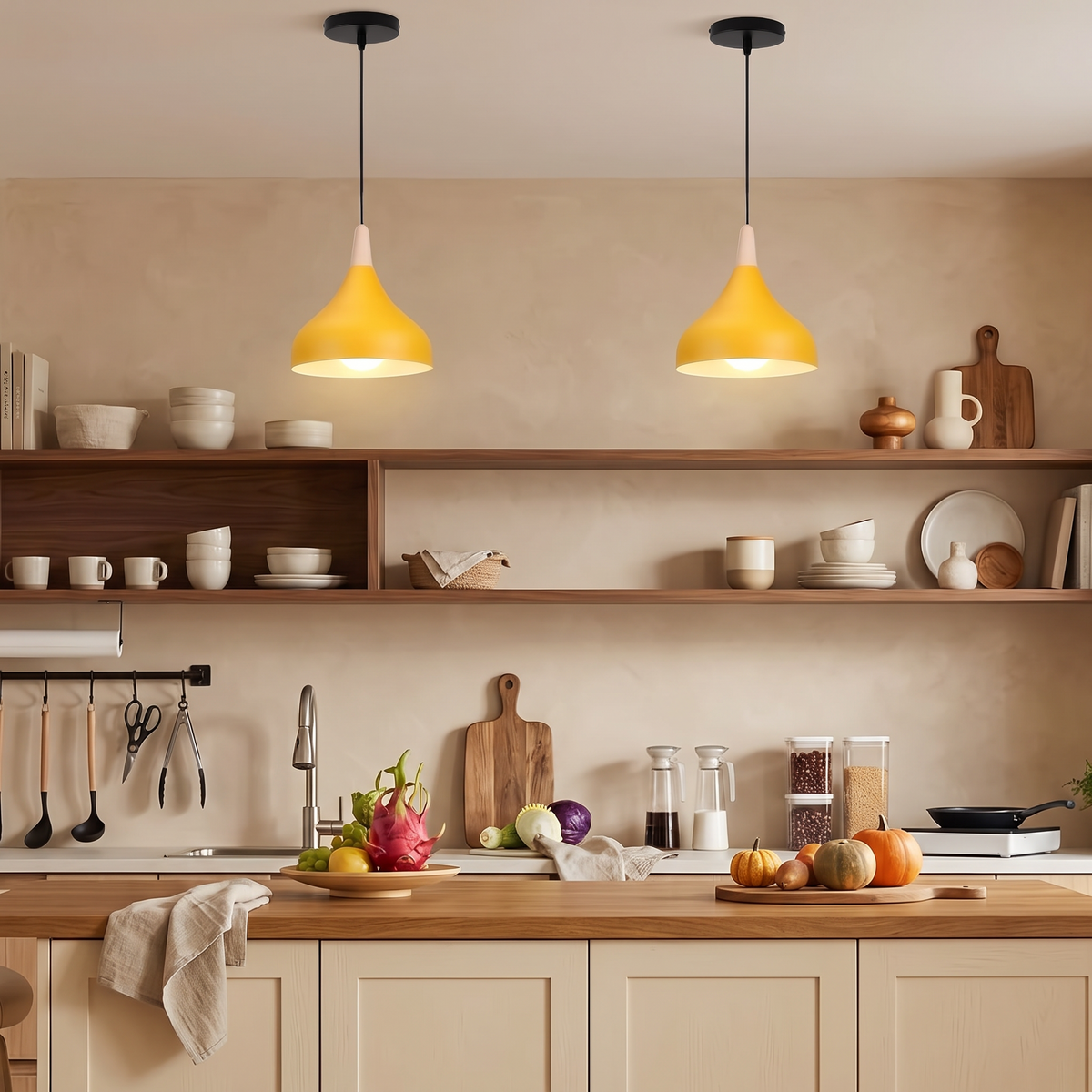 Two mustard yellow teardrop pendant lights above a kitchen with walnut shelves and a warm beige wall