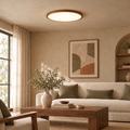 Ultra-slim walnut LED ceiling light in a warm beige living room with linen sofa